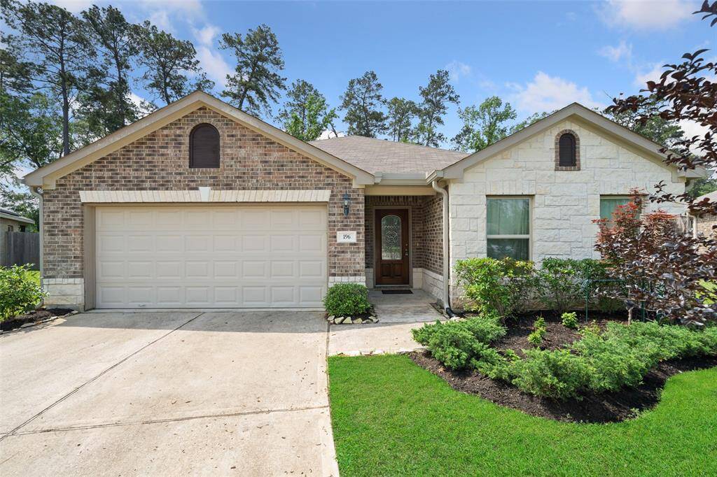 Charming single-story home with a brick and stone exterior, featuring a two-car garage and a welcoming front entrance. Surrounded by well-maintained landscaping and lush greenery, it offers a pleasant curb appeal in a serene neighborhood setting.