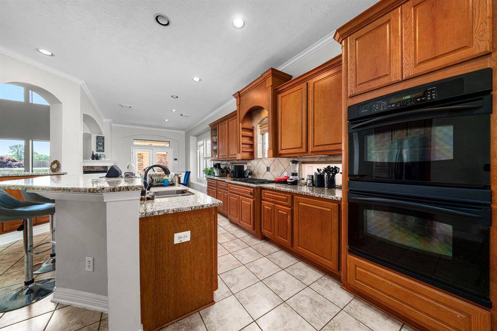 Spacious kitchen with glimpse of luxury Primary Den Area