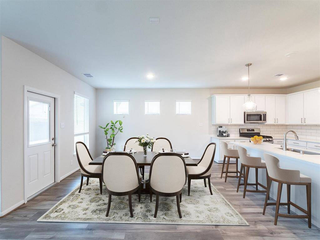 Plenty of seating at the island in the kitchen. Great space to gather & entertain.Virtually Staged.