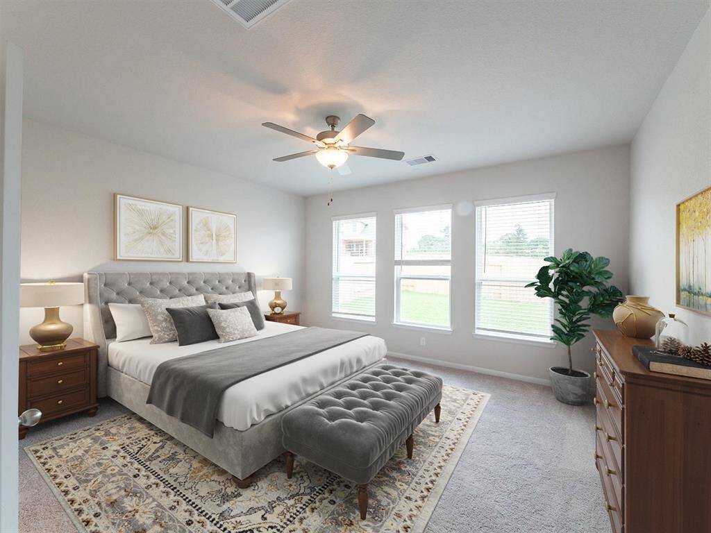 Primary bedroom offers plenty of sunlight & space.Virtually Staged.