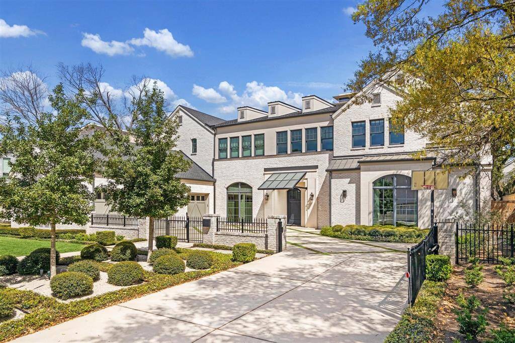 A luxurious Oak Estates home, this property showcases impeccable designer finishes throughout. The striking exterior blends brick, stone, and stucco, highlighted by elegant bronze lanterns and exceptional craftsmanship. A private drive leads to a beautifully gated motor court, revealing a spacious three-car garage.