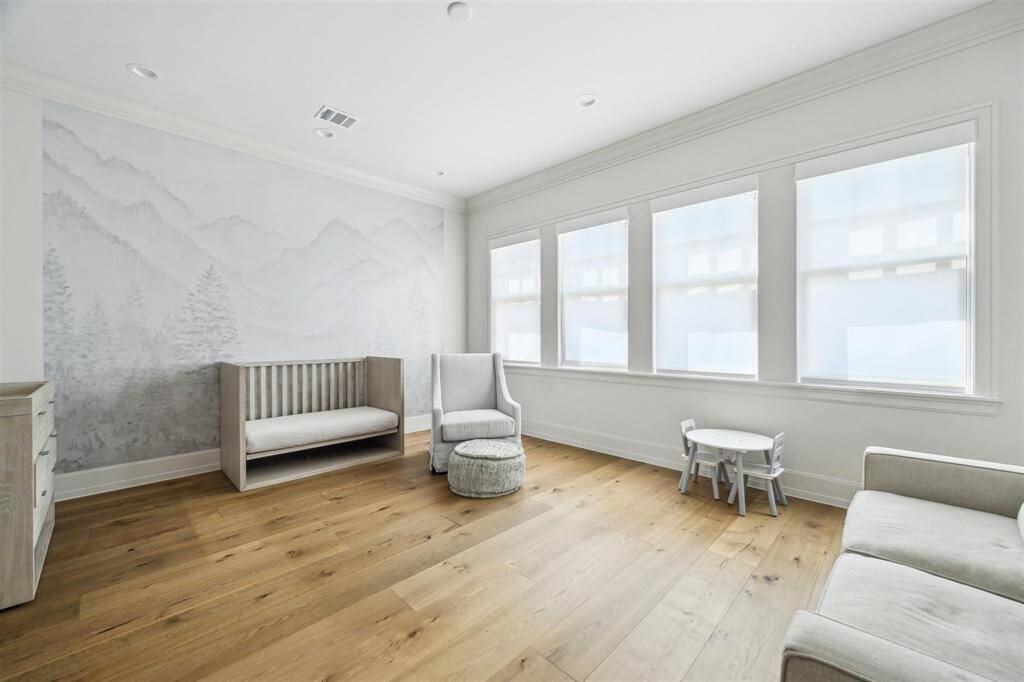 The generously sized secondary bedrooms in this exceptional home are bathed in natural light, each offering a luxurious en-suite, spacious walk-in closet, and elegant white oak hardwood floors.