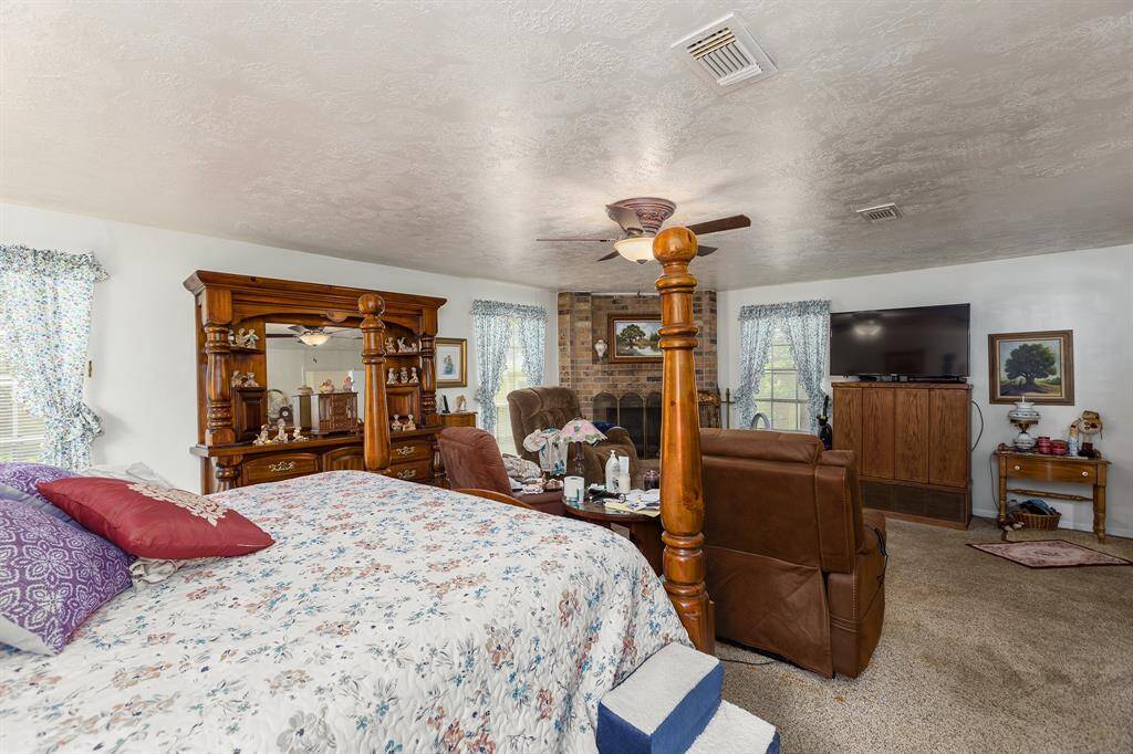 Primary bedroom has large sitting area and tons of privacy at the back of the house