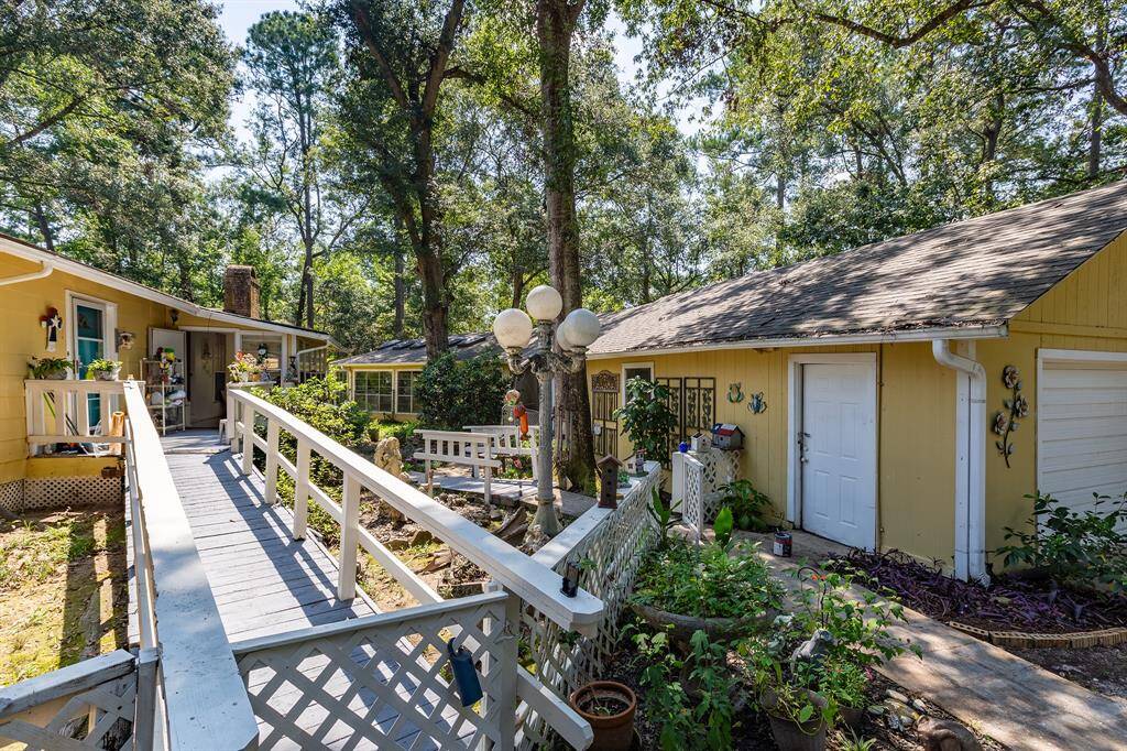 Courtyard area leading to side door, garage, and pool house