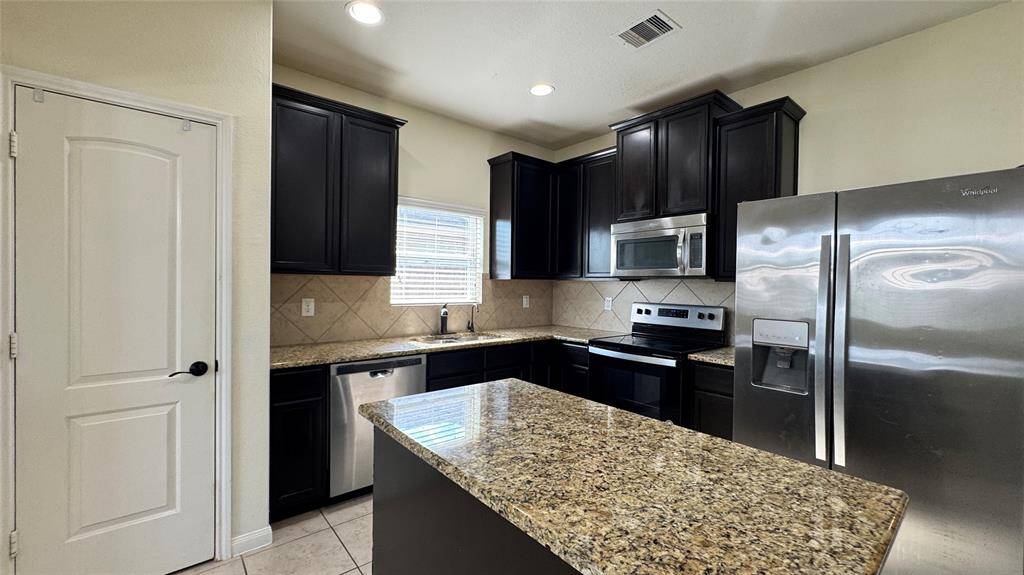 Stainless appliances and refrigerator included