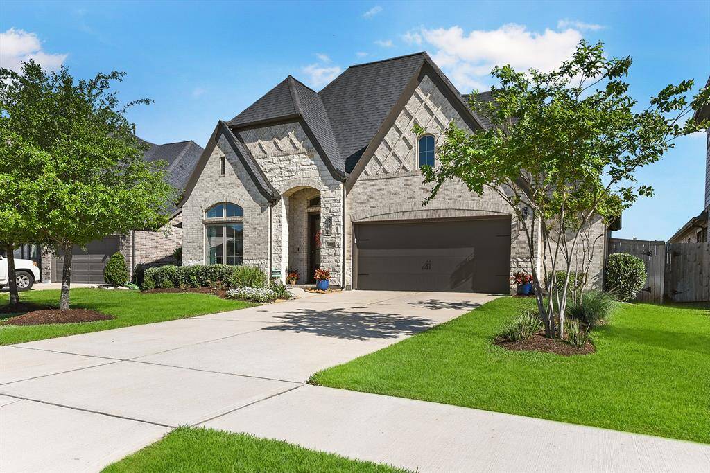 Home showcases an all brick and stone elevation that adds impressive curb appeal. The oversized 2-car garage includes a 5-foot extension, offering the perfect space for a workshop or additional storage.
