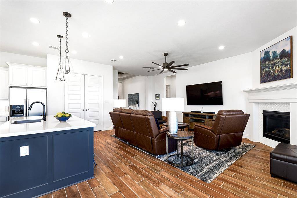 From the kitchen sink, you can easily interact with your guests, with the charming farmhouse sink and drop-down pendant lighting adding to the appeal. Double doors lead into the pantry. This kitchen will WOW you with its spaciousness, functionality, and beauty – truly a standout feature!