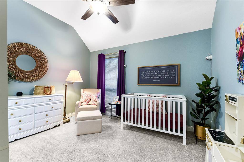 This junior ensuite is connected to a full bath, offering plenty of room in the guest bedroom. With ample space for a crib and a play place, it highlights the room's spaciousness.