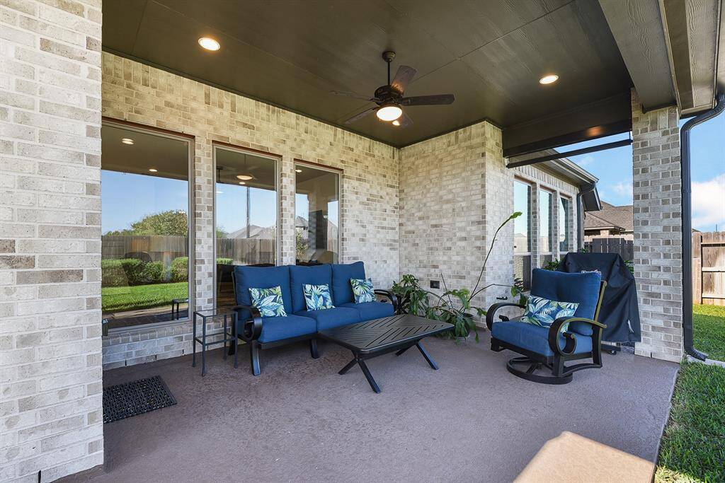A closer look at the covered backyard patio reveals the perfect space for relaxing, as well as an ideal spot for outdoor cooking and dining.