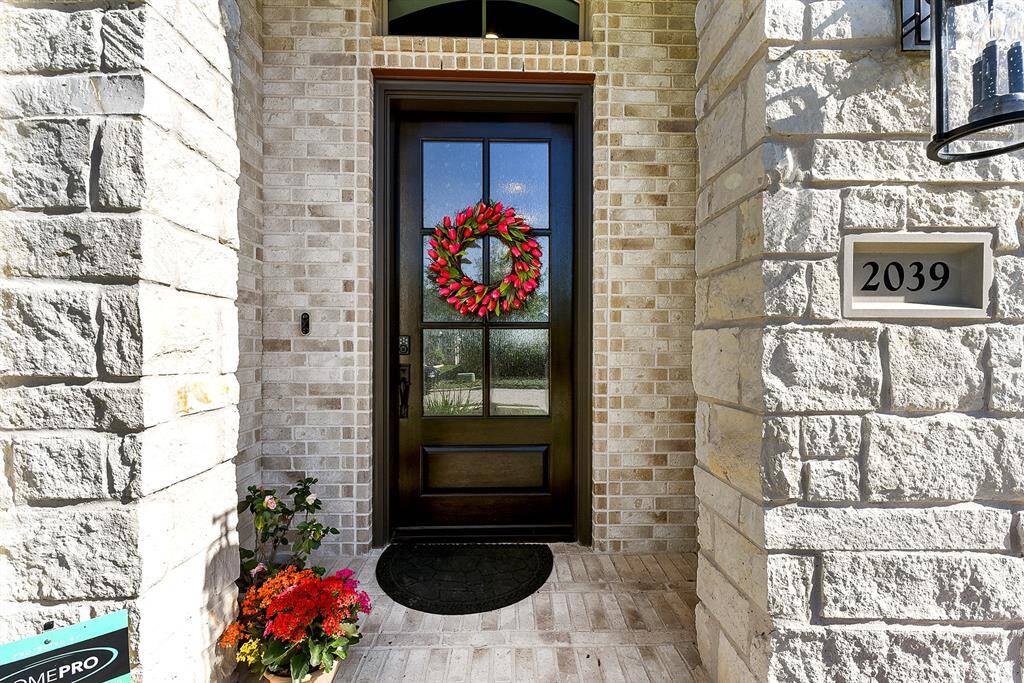 A welcoming covered front entry features a modern keyless entry system, great for convenience.