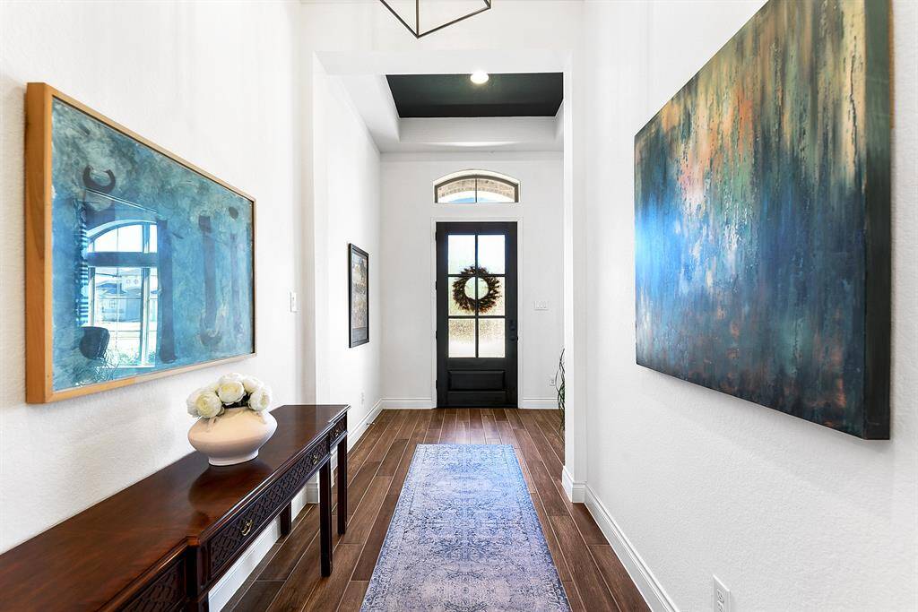 From the front door, to the right, you'll find French doors leading to the home office, offering picturesque views of the front yard.