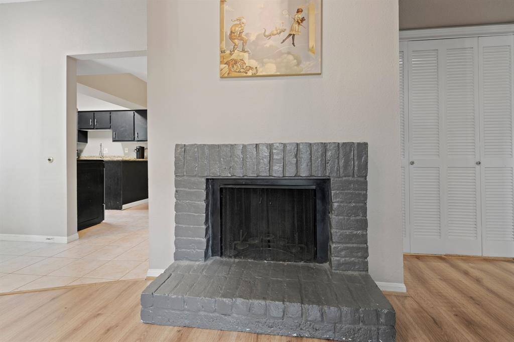 The fireplace is a striking centerpiece in the room, adding a modern yet cozy touch to the space. Its sleek metal screen enhances the design while ensuring both warmth and functionality for everyday living.