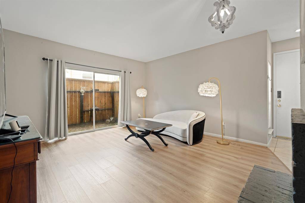 The large sliding patio doors invite natural light into the living room, creating an airy and open feel while seamlessly connecting indoor and outdoor spaces. Their generous size enhances the room’s spaciousness, offering easy access to the patio and framing a peaceful view outside.