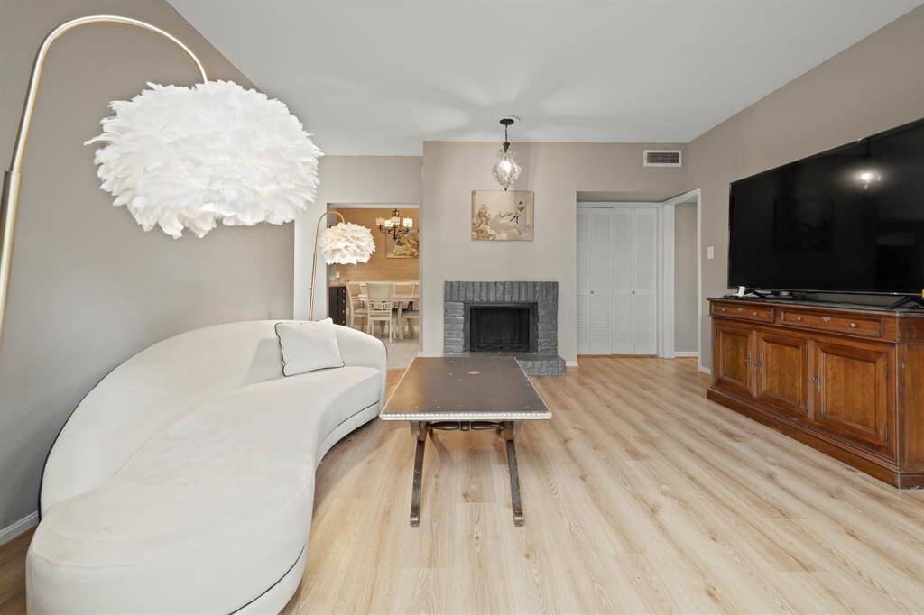 This angle highlights the inviting nature of the spacious living room, showcasing its seamless connectivity to every part of the condo. The open design enhances flow and functionality, making it a perfect space for comfortable living.