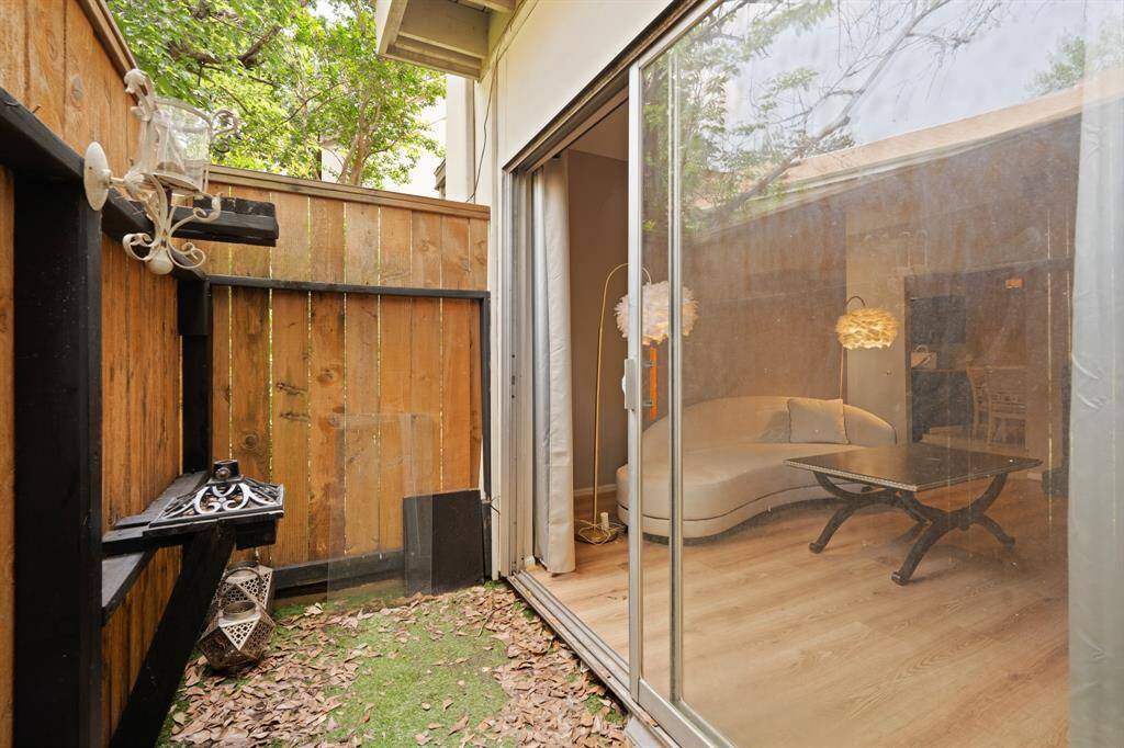 The sliding glass doors leading into the living room are a standout feature, providing seamless access between indoor and outdoor areas. These doors allow natural light to flood the living space and make transitioning between environments effortless, whether you're hosting guests or enjoying a peaceful moment outside.