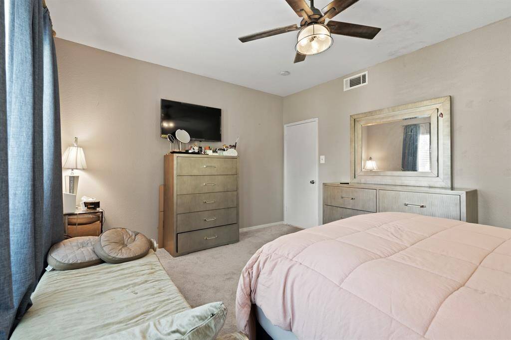 This angle showcases the spacious layout of the primary bedroom, where natural light enhances the open and airy feel of the space. The recently updated carpet and padding add an extra layer of comfort, creating a soft and inviting foundation throughout the room