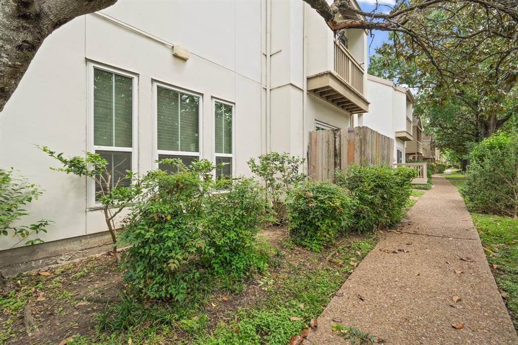 The walkway provides convenient access to additional units while maintaining a serene, landscaped environment that complements the overall aesthetic of the property.