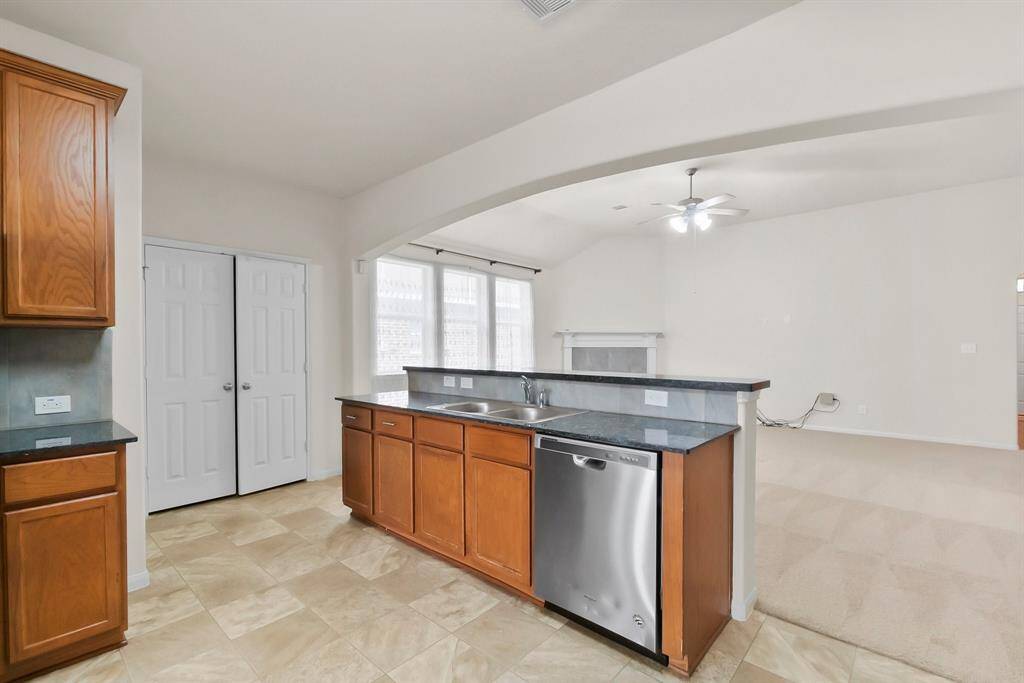 Bright, open kitchen and dining area with large windows, modern appliances, granite countertops, and ample cabinet space. Ideal for family gatherings and entertaining.