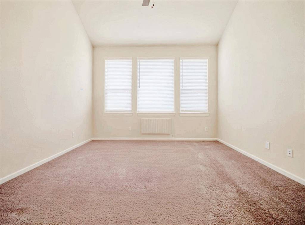 Experience luxury in the primary bedroom with vaulted ceilings and breathtaking lake views, complemented by plush carpeting with a 5-year warranty.