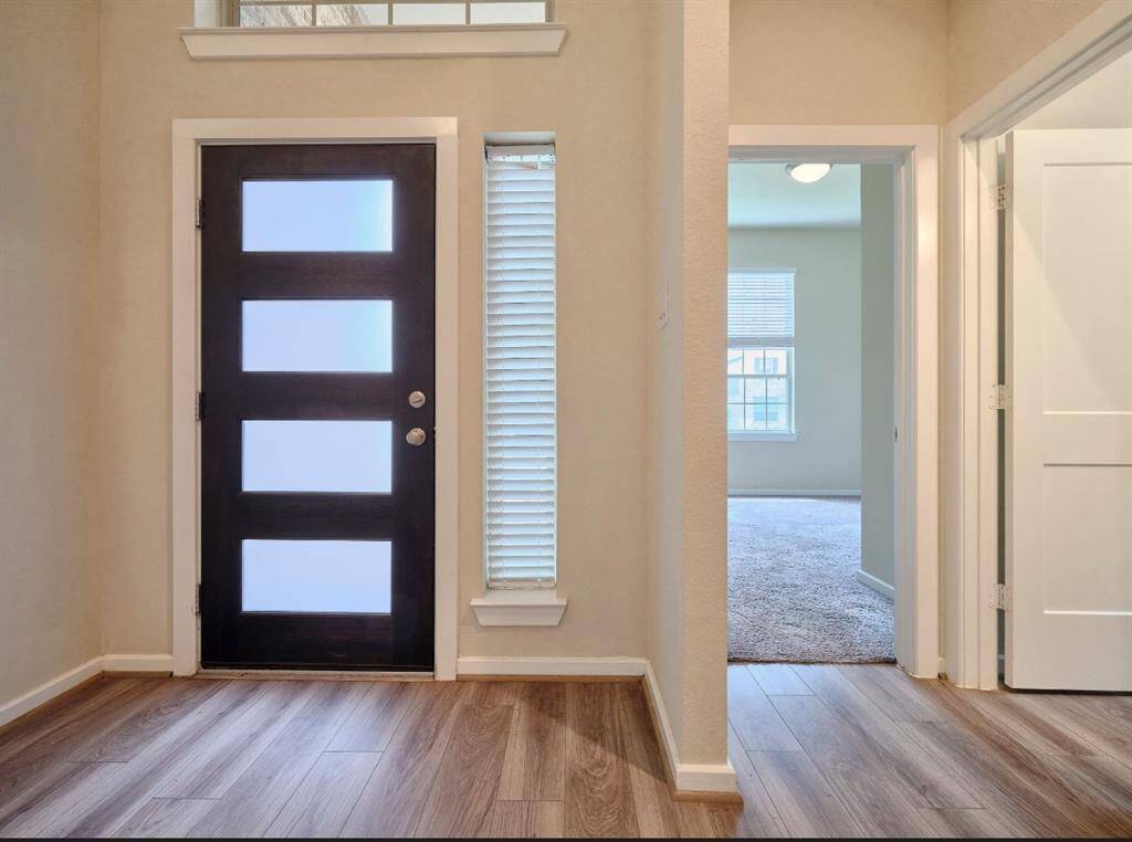 Experience the grandeur of a soaring entryway featuring an elegant 8-foot mahogany door.