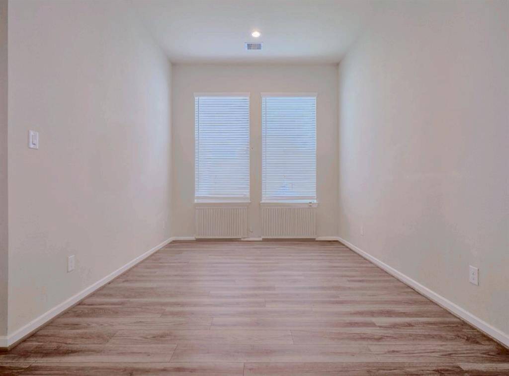A private study seamlessly accessible from the living area.2" faux wood blinds in all windows