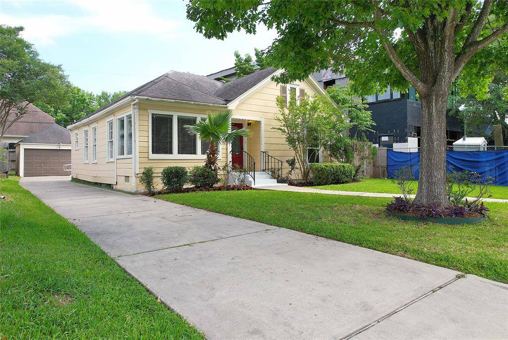 Charming and welcoming entrance with recent driveway and the detached two car garage. Plenty of room for additional parking on this driveway. The well-maintained yard has sprinkler system and features mature trees and manicured landscaping, creating a cozy and inviting atmosphere.