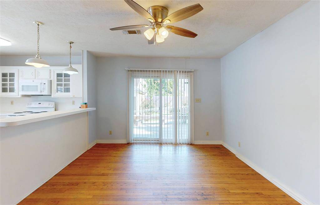 A view of the dinning room area which opens to the backyard with the sliding door and reached the deck.