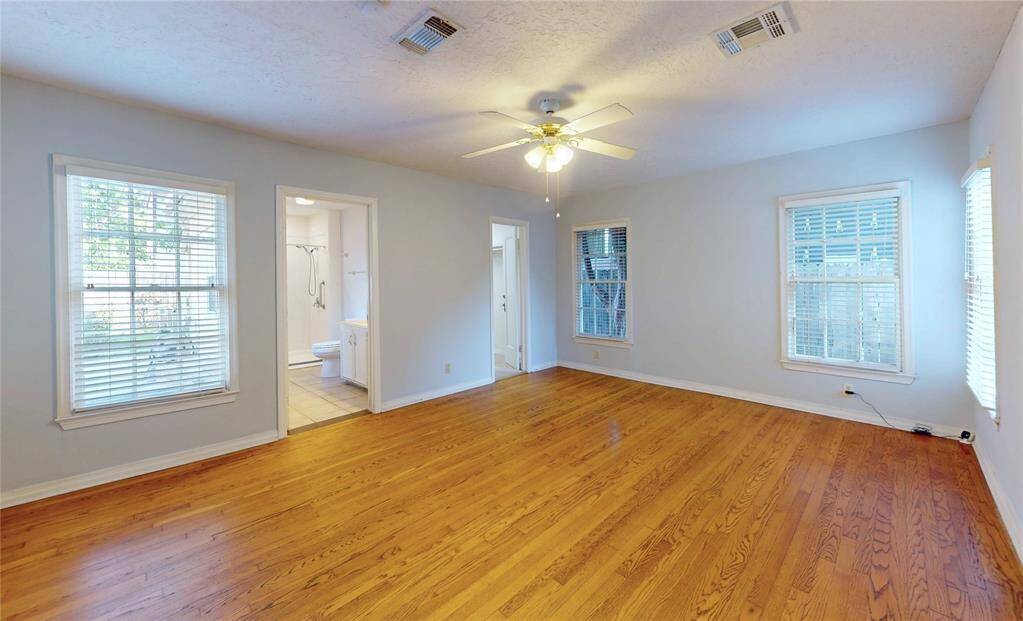 Generous size primary bedroom with a window overlooking the private backyard (left).  Primary bathroom with fully accessible recent shower and also a walkin closet.  Please note the hardwood floors throughout the house.