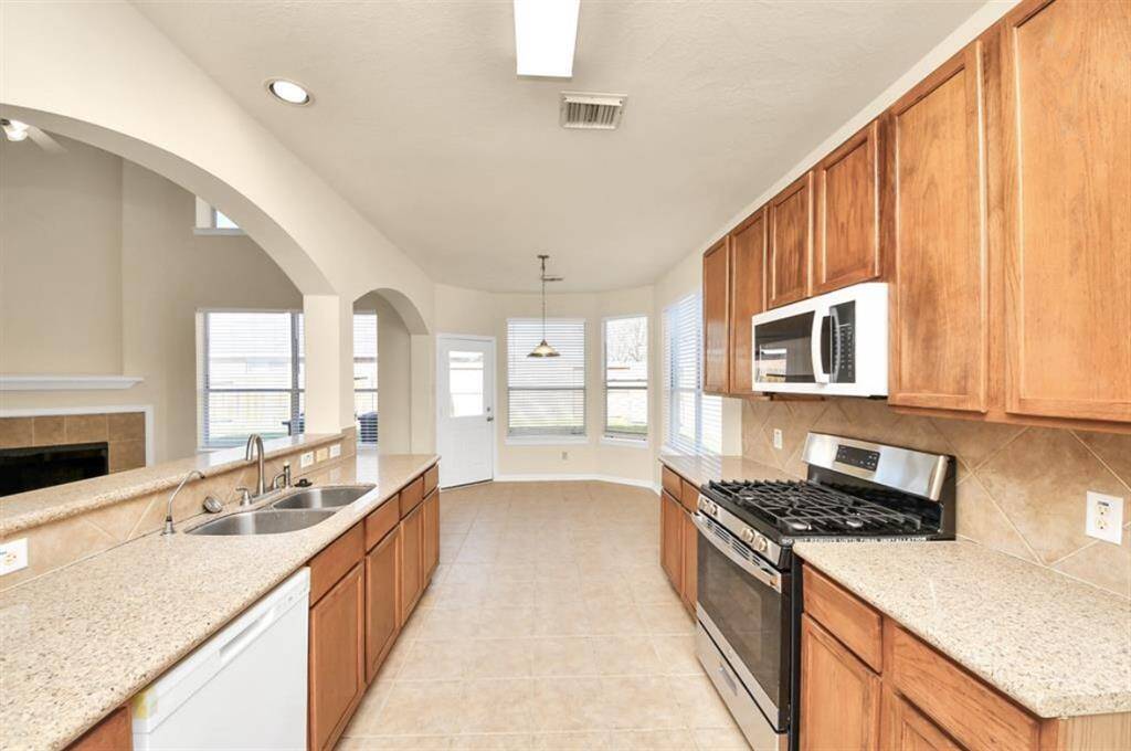 Granite kitchen with new dishwasher and stove