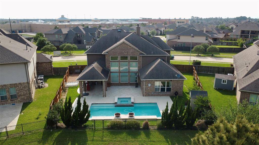 This spacious two-story brick home features a large backyard with a pool and patio area, ideal for entertaining. It’s located in a suburban neighborhood with nearby amenities, offering a perfect blend of comfort and convenience.