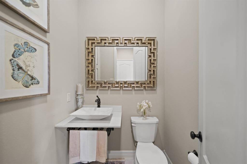 The half bath is beautifully accented with an upgraded pedestal sink.