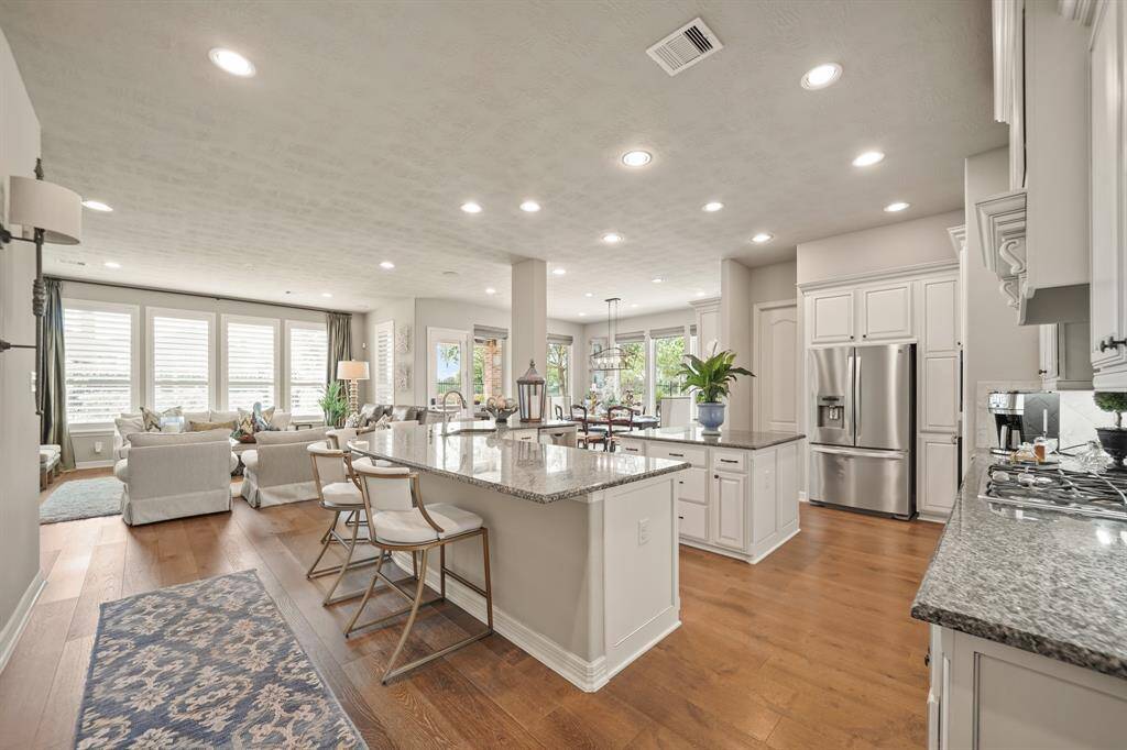 This well designed kitchen offers ease of flow for entertaining and an abundance of seating, counter and storage space.