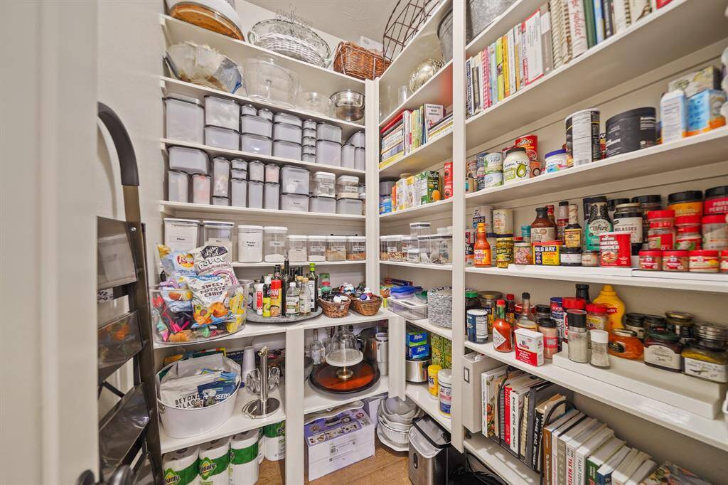 The walk-in pantry features an abundance of storage space.