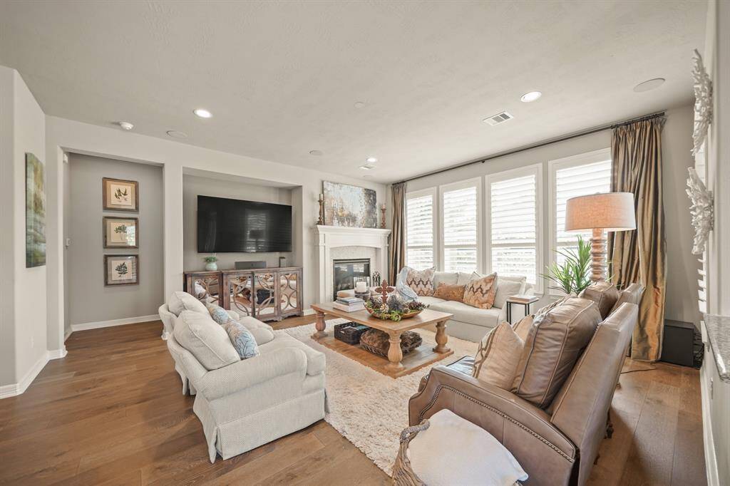 A gas log fireplace, ceiling mounted upgraded surround sound, wood floors and beautiful views make this family room sure to be a favorite spot for family gatherings.
