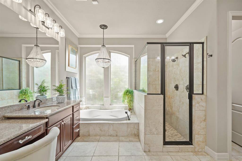 The primary bath is a sanctuary with its natural light, ample space, soaking tub, dual vanities and upgraded light fixtures.