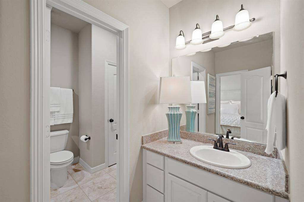 A jack and Jill style bathroom is located between the two upstairs bedrooms. Upgraded granite countertops and tile shower surrounds create an elevated space.
