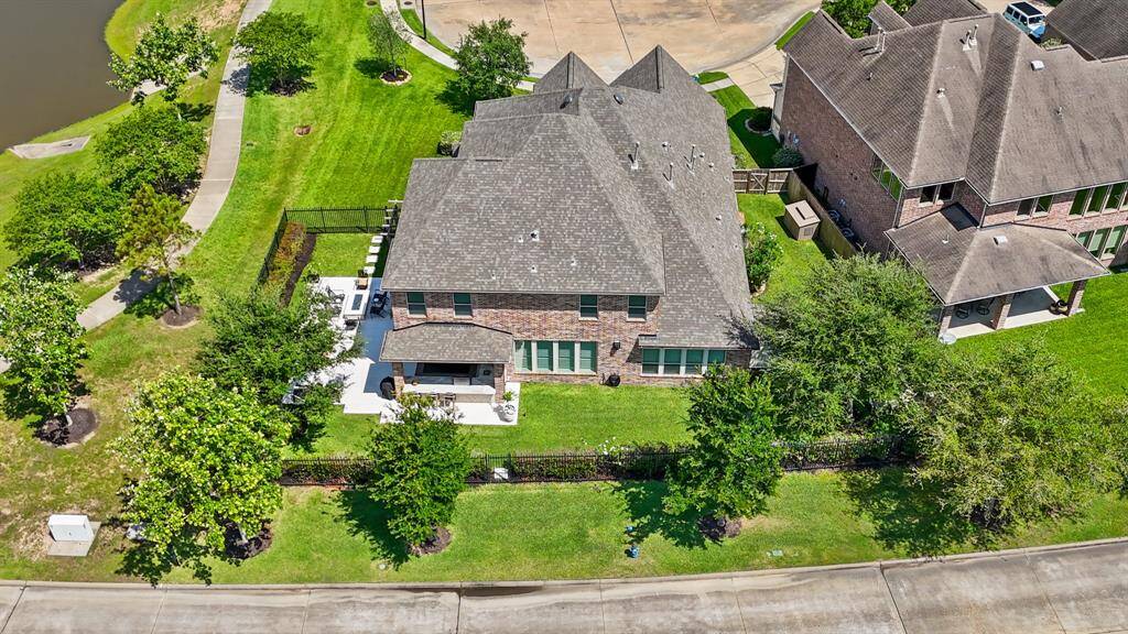 The spacious lot features ample room for the outdoor kitchen, seating area with fire pit, swing, garden, storage shed and plenty of room to add a pool if desired.