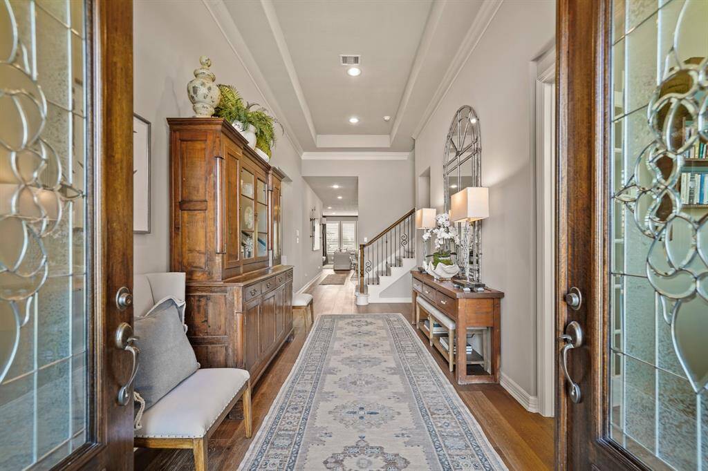 Step into luxury living.....the tiered ceiling and upgraded wood flooring create an inviting entry.