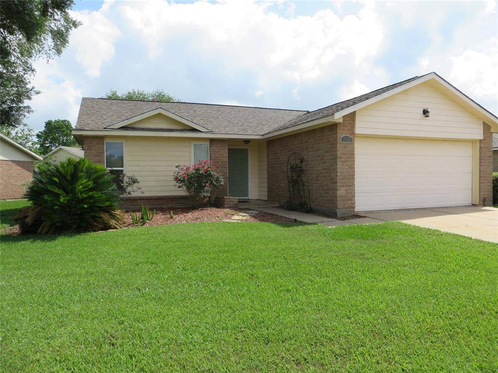 Nice yard and landscaping with two car garage attached.