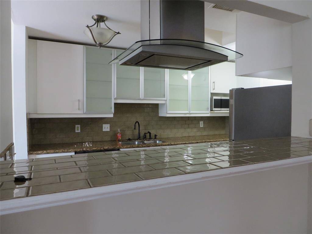 From the breakfast bar there is another view of the kitchen.