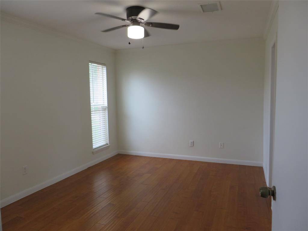 This is the primary bedroom which also has engineered wood flooring. There is a walk-in closet, too.