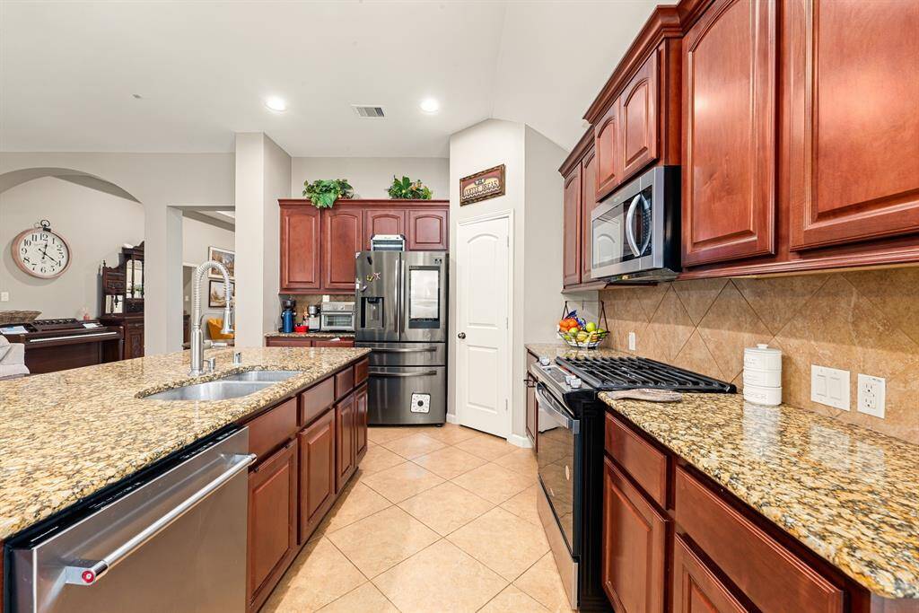 This well-organized kitchen includes ample cabinetry, a pantry, and easy access to dining areas.