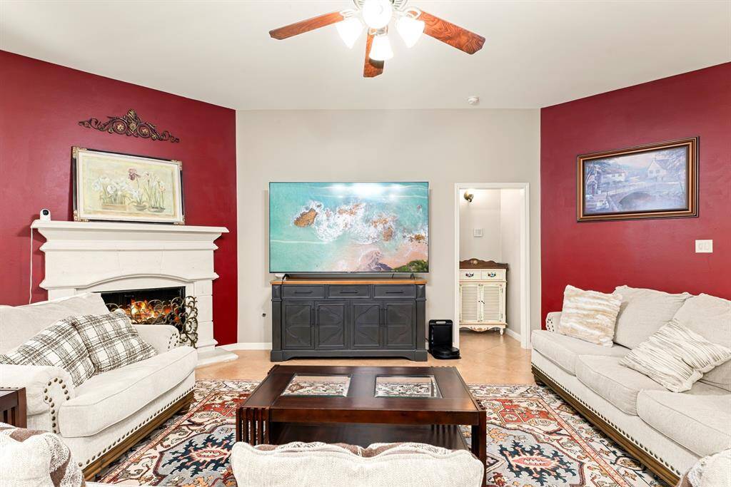 Comfort meets style in this inviting family room with ceiling fan and accent walls.