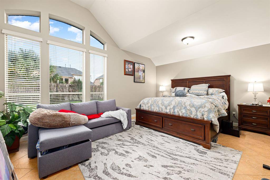 A serene primary suite overlooks the backyard and offers generous space for larger furniture and seating.