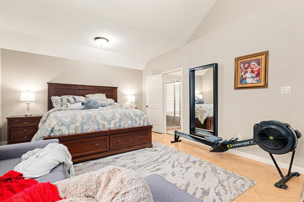 Spacious and sunlit, the primary bedroom offers a peaceful retreat with en-suite bath and updated Artika ceiling fan not pictured here.