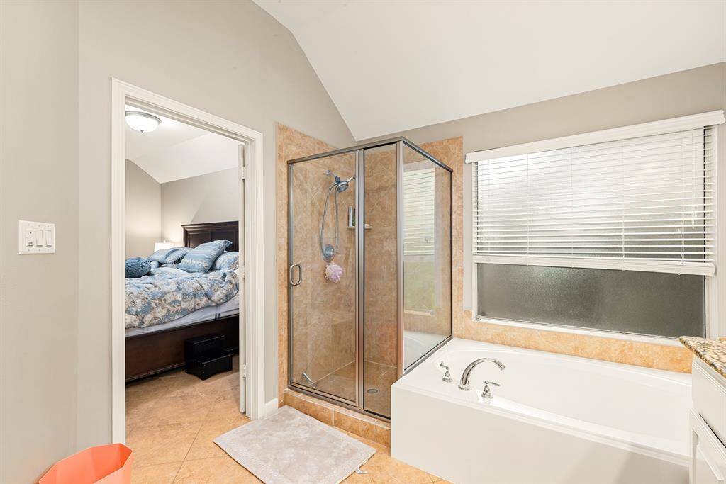 The primary bath features a relaxing soaking tub, separate shower, and dual vanities for added convenience.