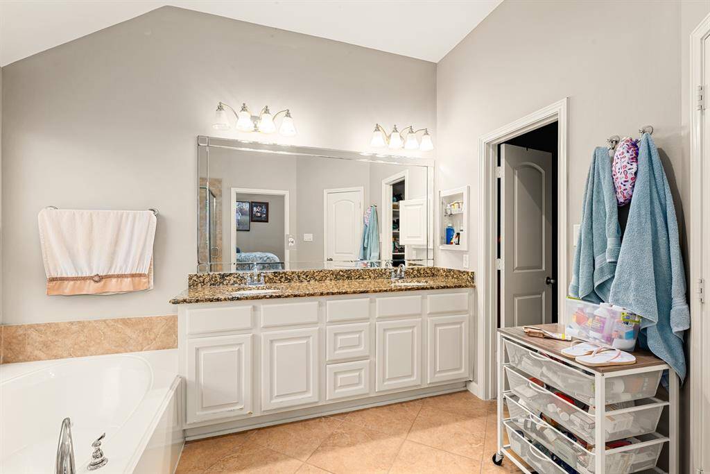 Designed with functionality in mind, this full bathroom offers a spacious vanity, neutral finishes and large window for an abundance of natural light.