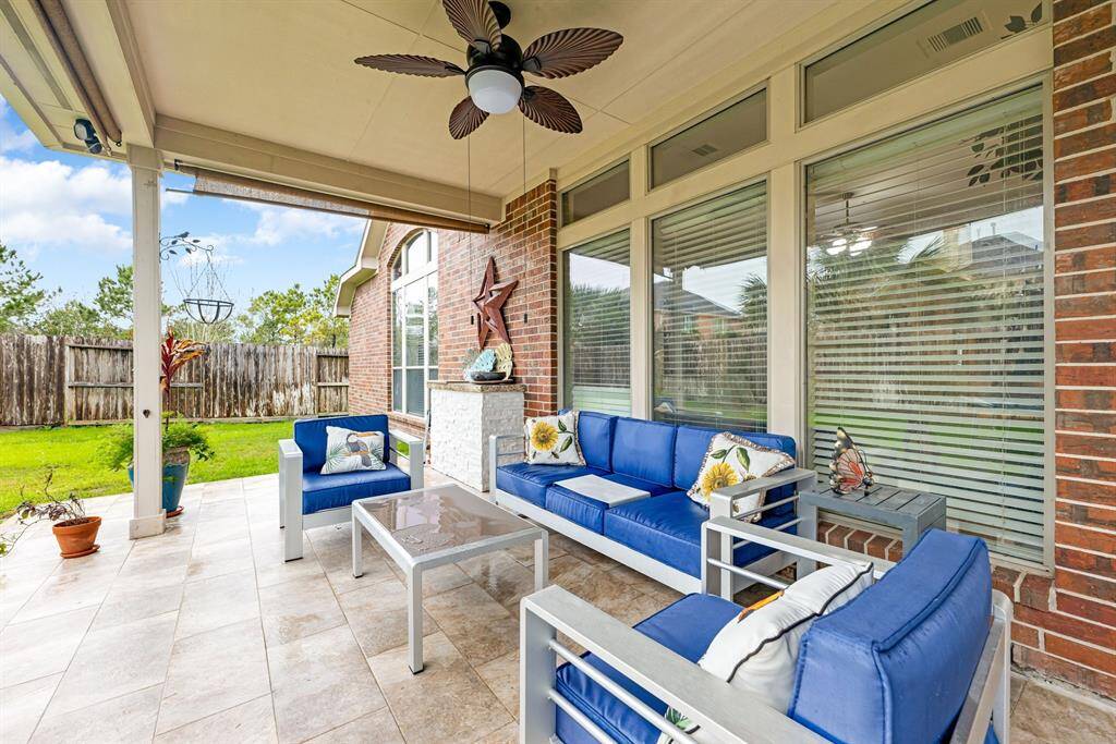 A second view of the extended patio showcases tile flooring and easy access to the lush backyard.