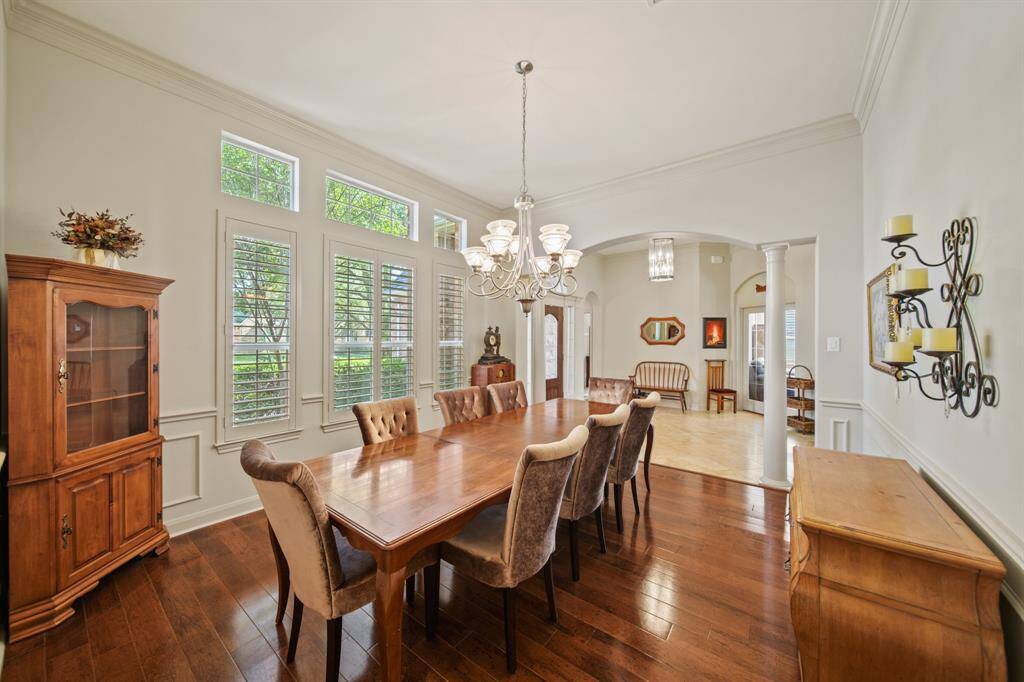 Elegant plantation shutters and rich wood flooring enhance the home's timeless charm.