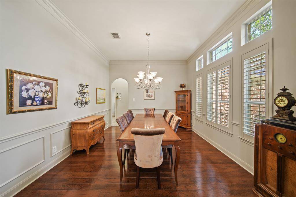 Elegant formal dining room featuring classic wainscoting and chair rails.